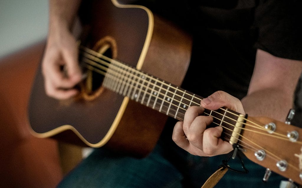 Pemula belajar memainkan kunci dasar gitar akustik